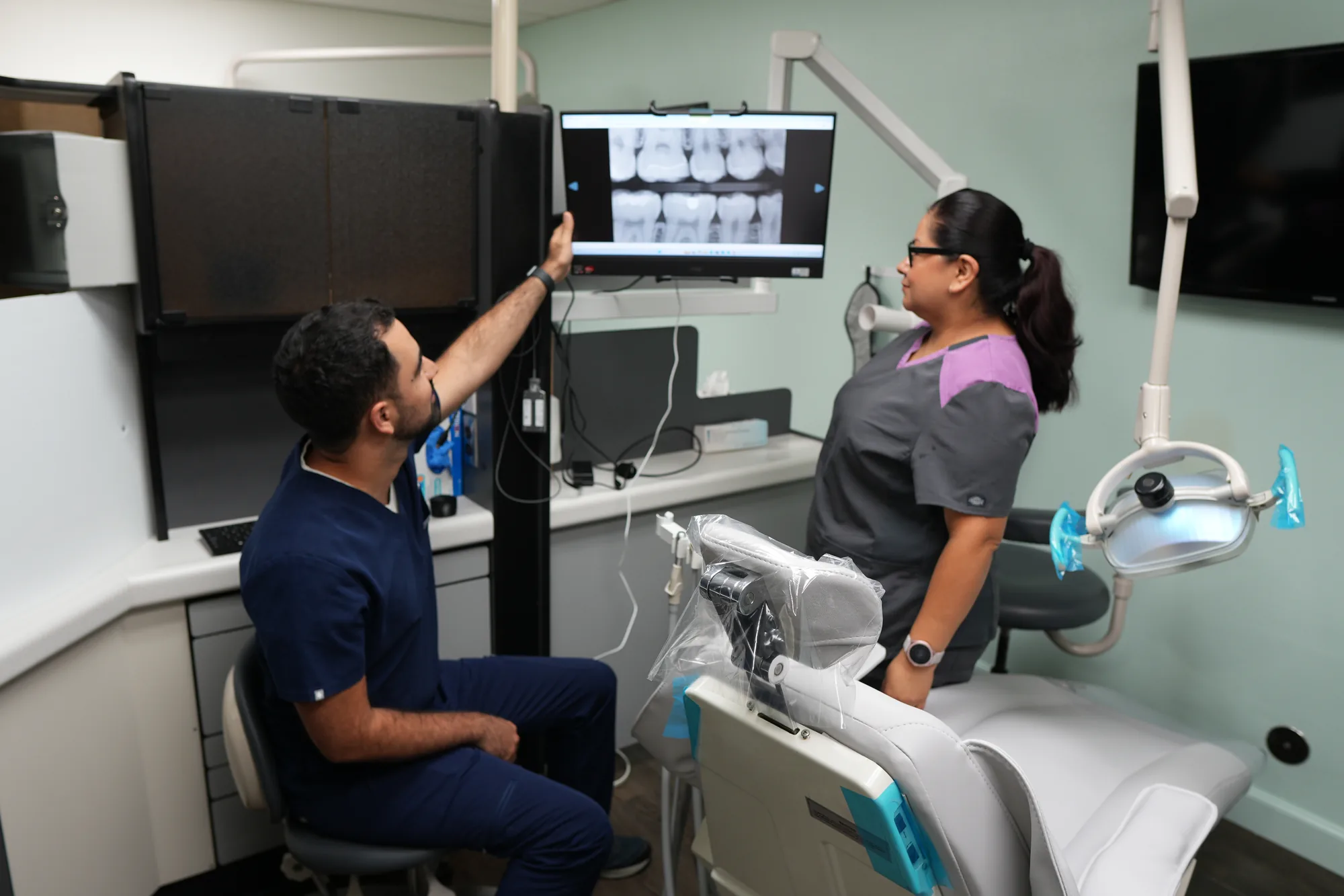 Dr. Dabirian reviewing digital X-rays with a patient